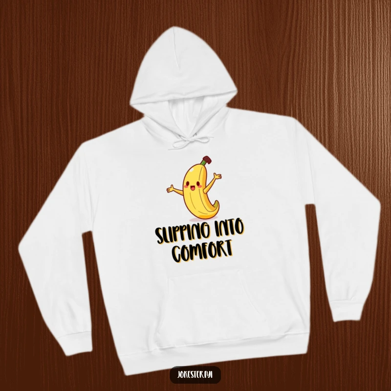 Funny banana hoodie showing a silly banana character tripping hilariously on a tiny peel, arms flailing wildly for maximum effect.