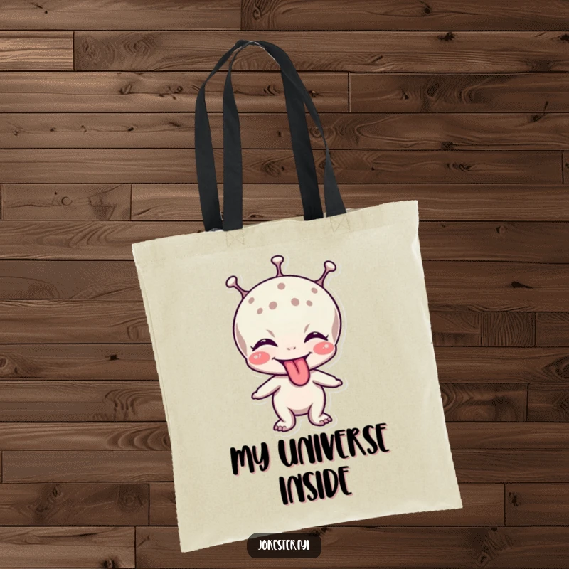 Funny tote bag featuring a giggling alien character adorably sticking out its tongue in a playful greeting.